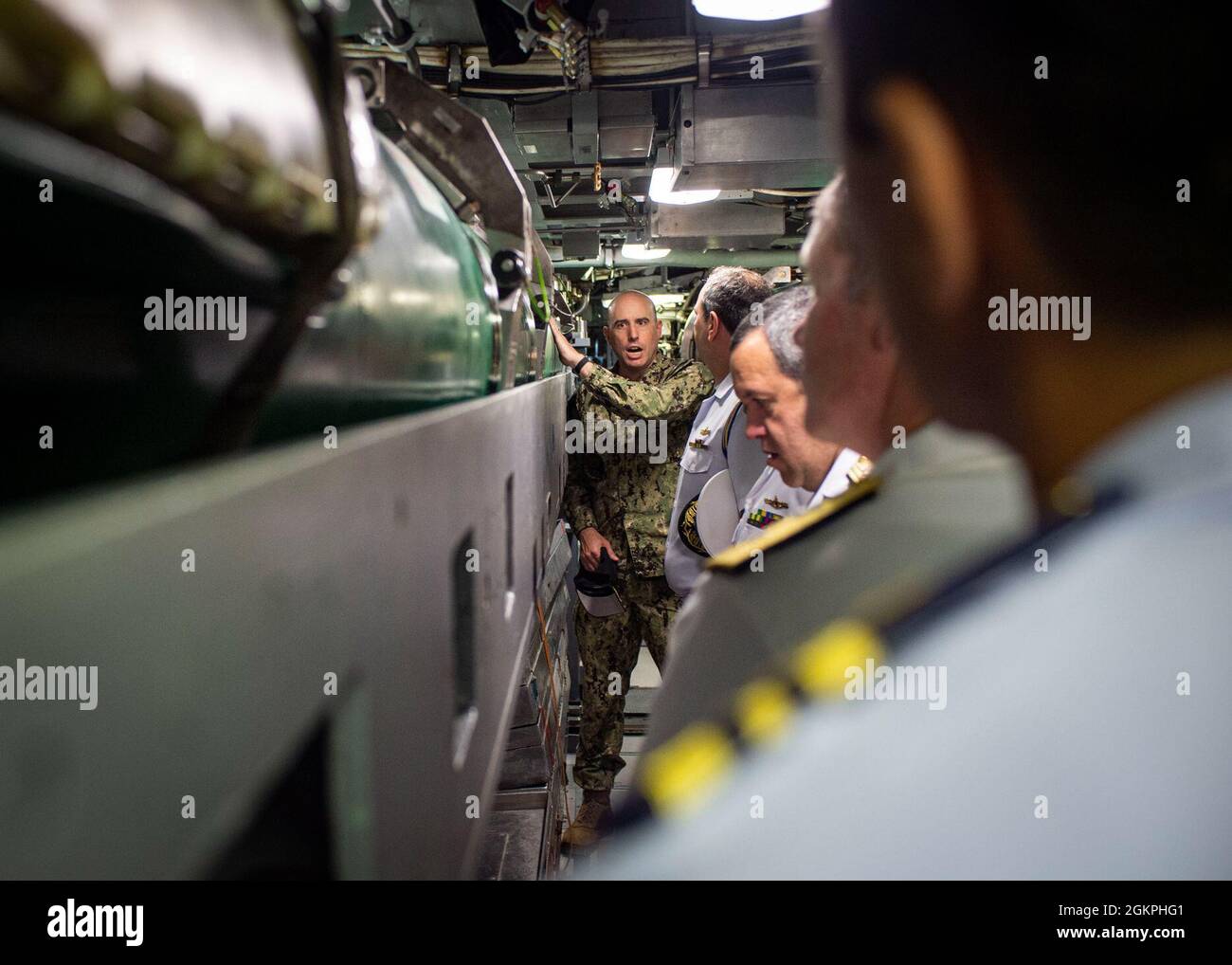 Bef. Bennett Christman, Kommandant der USS New Hampshire (SSN 778), Zentrum, führt Vice ADM durch den Torpedoraum des Bootes. Amaury Calheiros und ADM hinten. Rogerio Rodrigues, brasilianischer Naval-Attachés an Bord des Marinestützpunkts Norfolk, 14. Juni 2021. In Hampton Roads traf sich die brasilianische Delegation mit ADM. Christopher Grady, Kommandant, Fleet Forces Command, besuchte Commander, Submarine Forces, Und besichtigte die U-Boot-Lerneinrichtung. Stockfoto