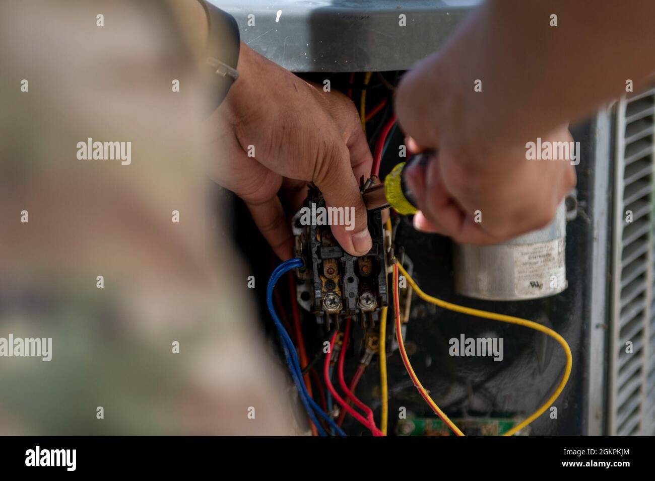 Joje Masaganda, Senior Airman, 4th Civil Engineer Squadron Heating, Ventilation, Air Conditioning and Refrigeration Technician, wechselt den Schütz einer Split-System-Klimaanlage auf der Seymour Johnson Air Force Base, North Carolina, 14. Juni 2021. Ein Schütz leitet die Leistung an die Komponenten in der von ihm steuerungen Einheit weiter. Stockfoto