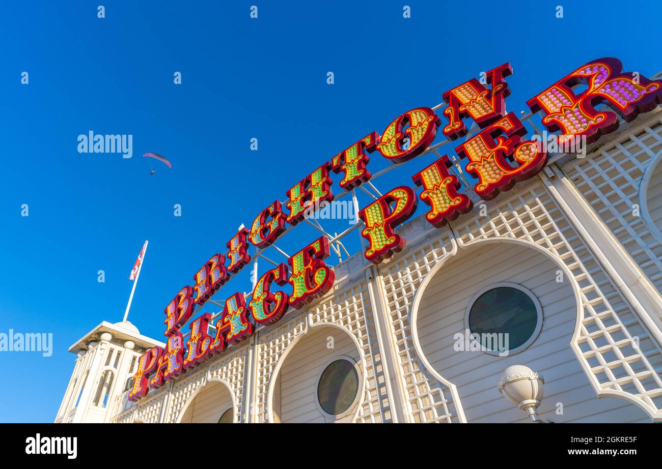 Blick auf den Gleitschirm und Schild an einem sonnigen Tag am Brighton Palace Pier, Brighton, East Sussex, England, Großbritannien, Europa Stockfoto