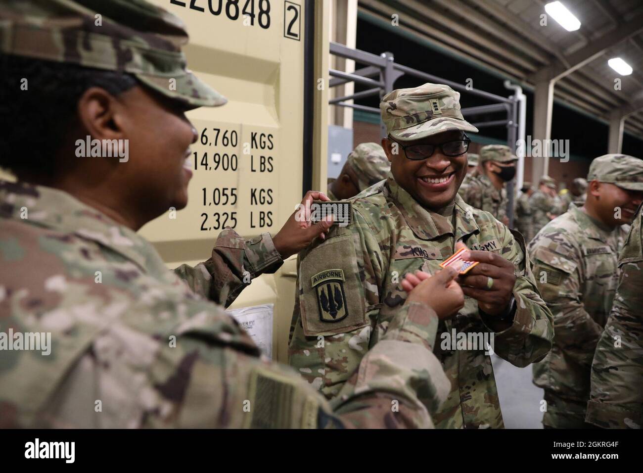 Sergeant Major Veronica Harvey, eine hochrangige Logistikerin, die dem Hauptquartier und der Hauptverwaltung, dem Division Special Trupps Bataillon, der 3rd Division Sustainment Brigade, zugewiesen wurde, ändert die US-Flagge des Chief Warrant Officer 3 Maurice King von HHC, 3rd DSTB, für eine gedämpfte Version, Bedeutung der IT-Abteilung, die vor dem Abflug von Fort Stewart im Juni 21 eingesetzt wurde. Die 3rd Division Sustainment Brigade wird für eine neunmonatige Rotation zur Unterstützung der Operation Spartan Shield eingesetzt, um logistische Unterstützung und Kontrolle im gesamten Einsatzgebiet des Central Command zu leisten. Stockfoto