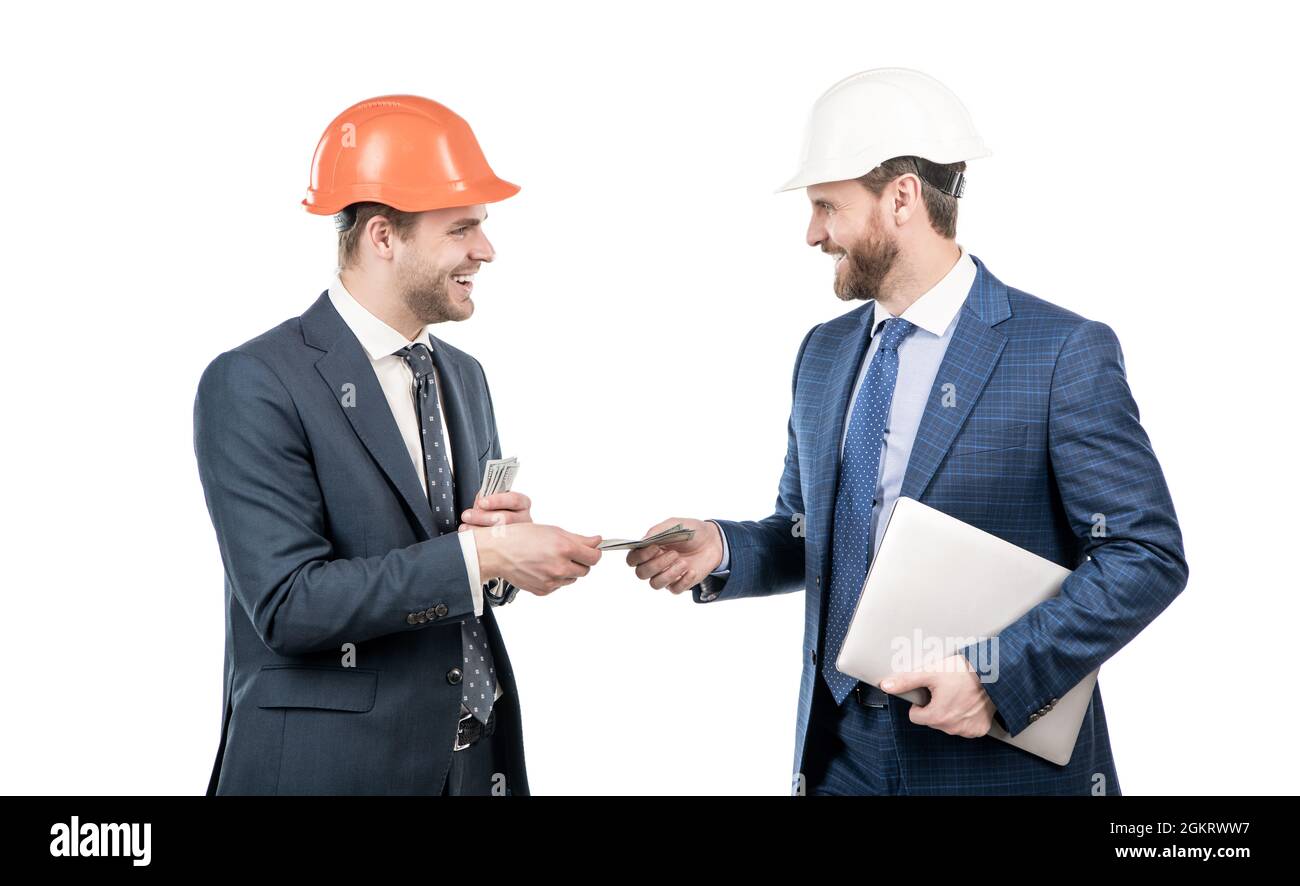 Investition in Architekturprojekt. Männer Geschäftsleute in Hardhat mit Geld und Laptop. Stockfoto