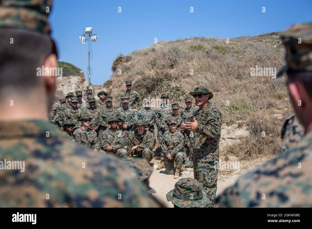 US Marine LT. Col. Frank Savarese, der Kommandant des Hauptquartiers und des Hauptquartiers Squadron, Marine Corps Air Station Camp Pendleton, führt vor einer Warrior Night am Red Beach auf dem Marine Corps Base Camp Pendleton, Kalifornien, 9. Juli 2021, eine Marinesoldaten ein. Die Warrior Night wurde abgehalten, um Kameradschaft und Esprit de Corps innerhalb der Staffel zu errichten. Stockfoto