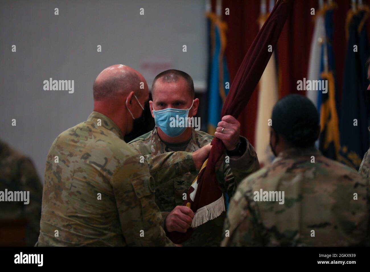 Col. Neil T. Roeder, ankommender Kommandant, 3. Medizinisches Kommando-Forward „Desert Medics“, erhält die Farben von Maj. General Chris Field, stellvertretender Generalkommandeur – Operationen, U.S. Army Central, während einer Zeremonie zur Übertragung der Autorität im Lager Arifjan, Kuwait, 16. Juli 2021. Roeder wird hier im Theater die Einheit 10 der Abteilung leiten. Stockfoto