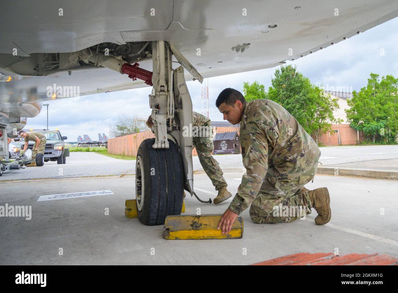 Kori Montgomery, Senior Airman der US Air Force, ein Spezialist für Luftreparaturen mit dem 461. Maintenance Squadron, dem 461. Air Control Wing, entfernt während eines F-4C Phantom II-Abschleppvorgangs auf der Robins Air Force Base, Georgia, 20. Juli 2021 einen Unterlegkeil. Die Betreuer des Teams JSTARS stellten den Jet wieder her und schleppten ihn auf eine Unterlage vor dem Hauptquartier des Flügels, wo er auf einer permanenten statischen Anzeige dargestellt wird, die die Flügellinie darstellt, als der ehemalige 116. Taktische Kämpfer-Flügel das Flugzeug von 1983 bis 1986 flog. Stockfoto