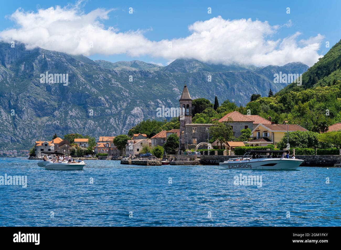 Blick auf die Boote in der Boka Bay, Montenegro. Eine Aufnahme der Boote in der Bucht von Kotor in Montenegro. Im Hintergrund ist eine alte Kirche zu sehen. Stockfoto