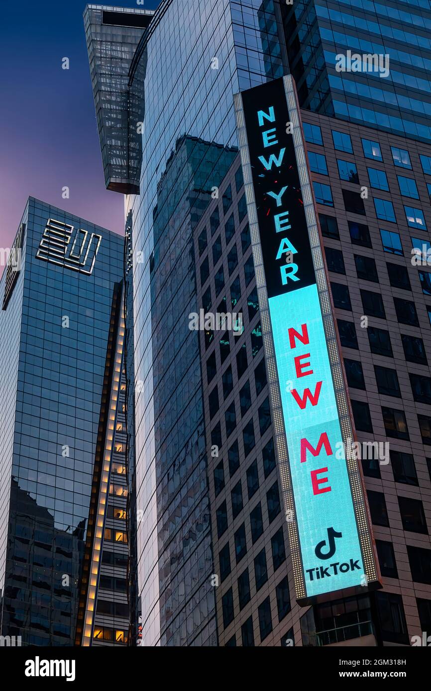 New Year New Me Tik Tok NYC - Blick auf den Times Square erleuchtetNeonschild das Ernst & Young Gebäude sowie andere Wolkenkratzer, die Teil bilden Stockfoto