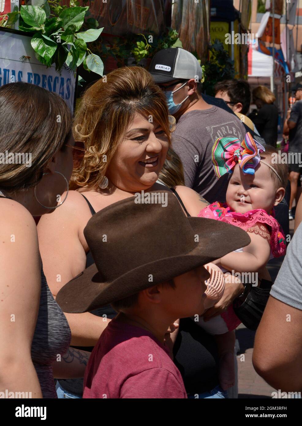 Eine Frau zeigt ihr kleines Kind Freunden während des jährlichen hispanic Fiesta Festivals in Santa Fe, New Mexico. Stockfoto