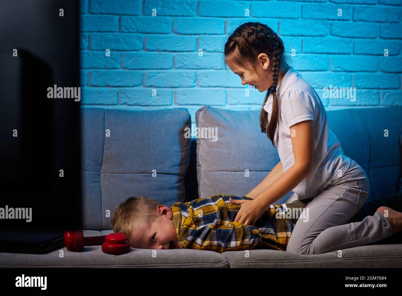 Fröhlicher Junge und Mädchen, die Spaß zu Hause zusammen Stockfoto