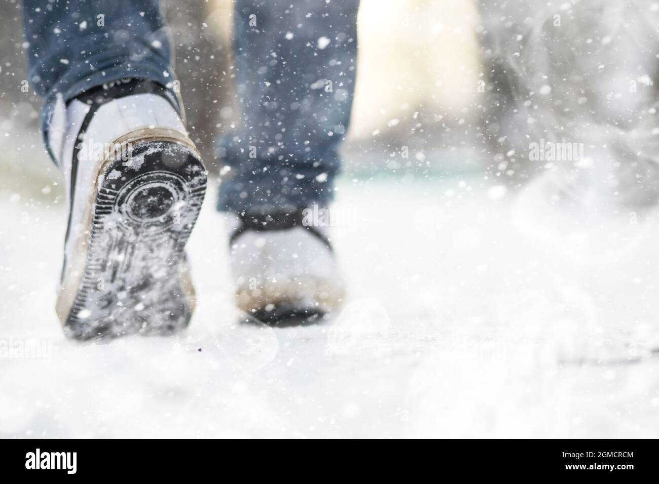 Ein Mann geht an einem verschneiten Wintertag durch die Stadt. Stockfoto