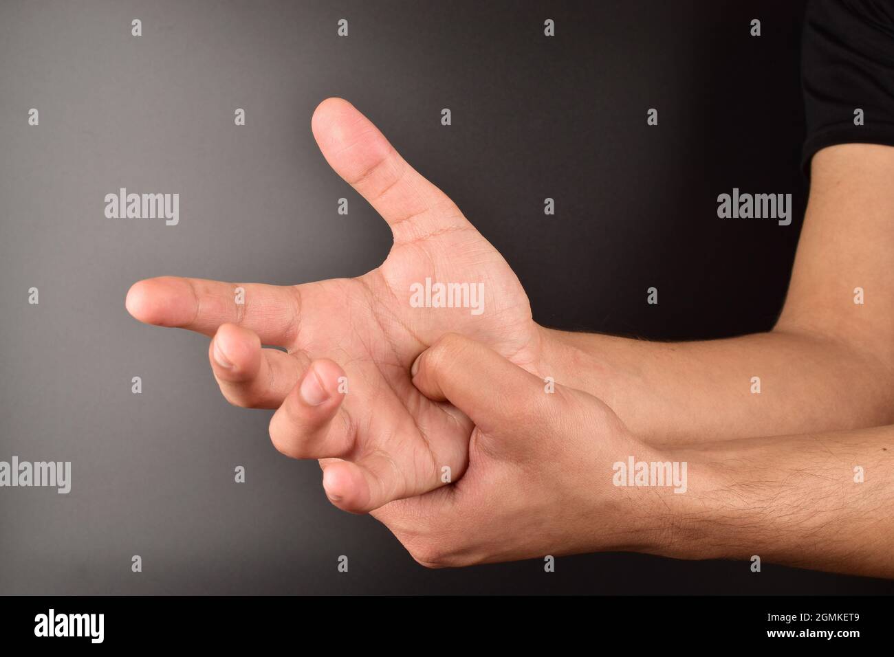 Mann macht Selbstaufdruck auf dunklem Hintergrund Stockfoto