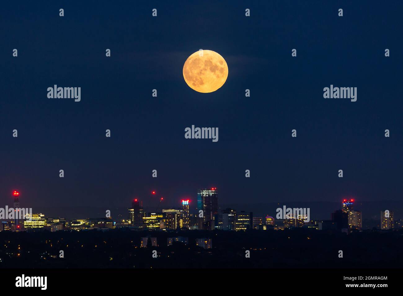 Birmingham, Großbritannien. September 2021. Ein glühender Erntemonel steigt über den Lichtern der Stadt Birmingham, Großbritannien, auf. Kredit: Peter Lopeman/Alamy Live Nachrichten Stockfoto