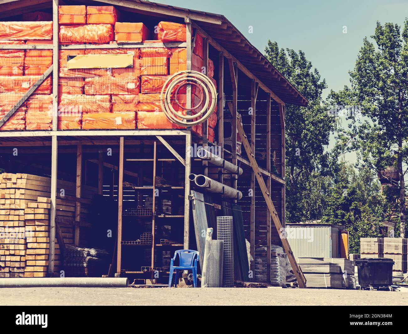 Baustoffe im Baumarkt. Holzbretter, Säcke aus Zement befinden sich auf den Regalen. Stockfoto