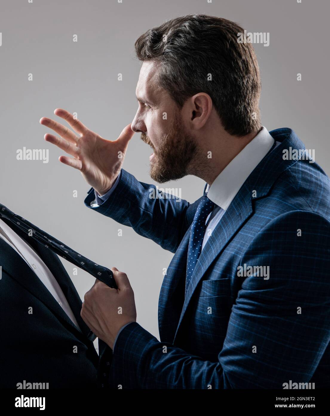 Aggressiver Anwalt in Anzug machen drohen Geste ziehen Mann Krawatte grauen  Hintergrund, bedrohlich Stockfotografie - Alamy