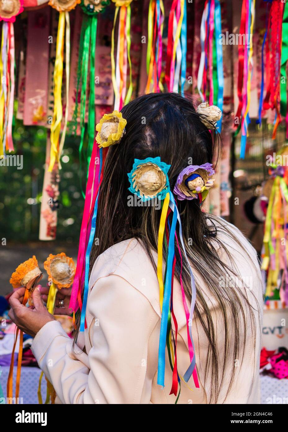 Frau arrangiert Mini-Hüte mit Bändern zum Verkauf auf der Belo Horizonte Hippie Fair in Brasilien. Diese Haarschmuck sind für die Festa Junina, ein Brasilien. Stockfoto