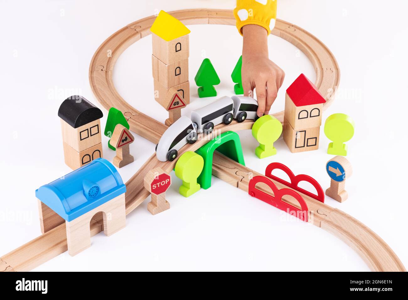 Hölzerne Zug- und Eisenbahnstraße pädagogisches Spielzeug für Kinder auf weißem Hintergrund Stockfoto