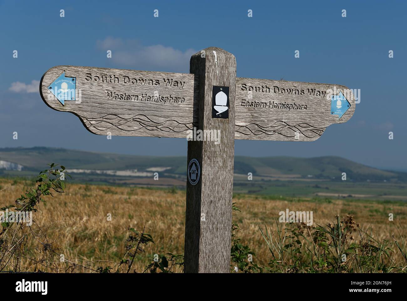 Holzschild auf dem South Downs Way in Sussex, das den Greenwich Meridian markiert Stockfoto