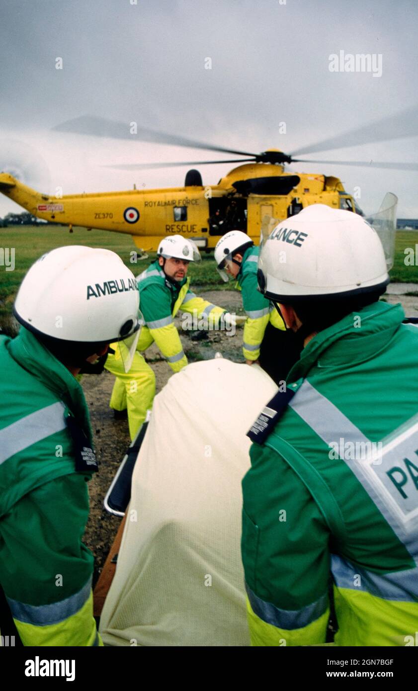 Sanitäter tragen einen simulierten verletzten Passagier während einer Zivilverteidigungsübung zu einem wartenden Hubschrauber. Stockfoto