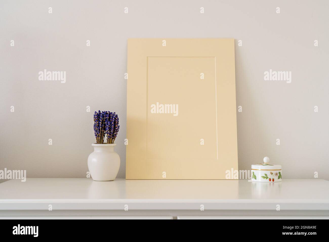 Pappbild für die Bilderfassung im Innenraum mit einer Vase mit Lavendel und einem kleinen Schmucktopf Stockfoto