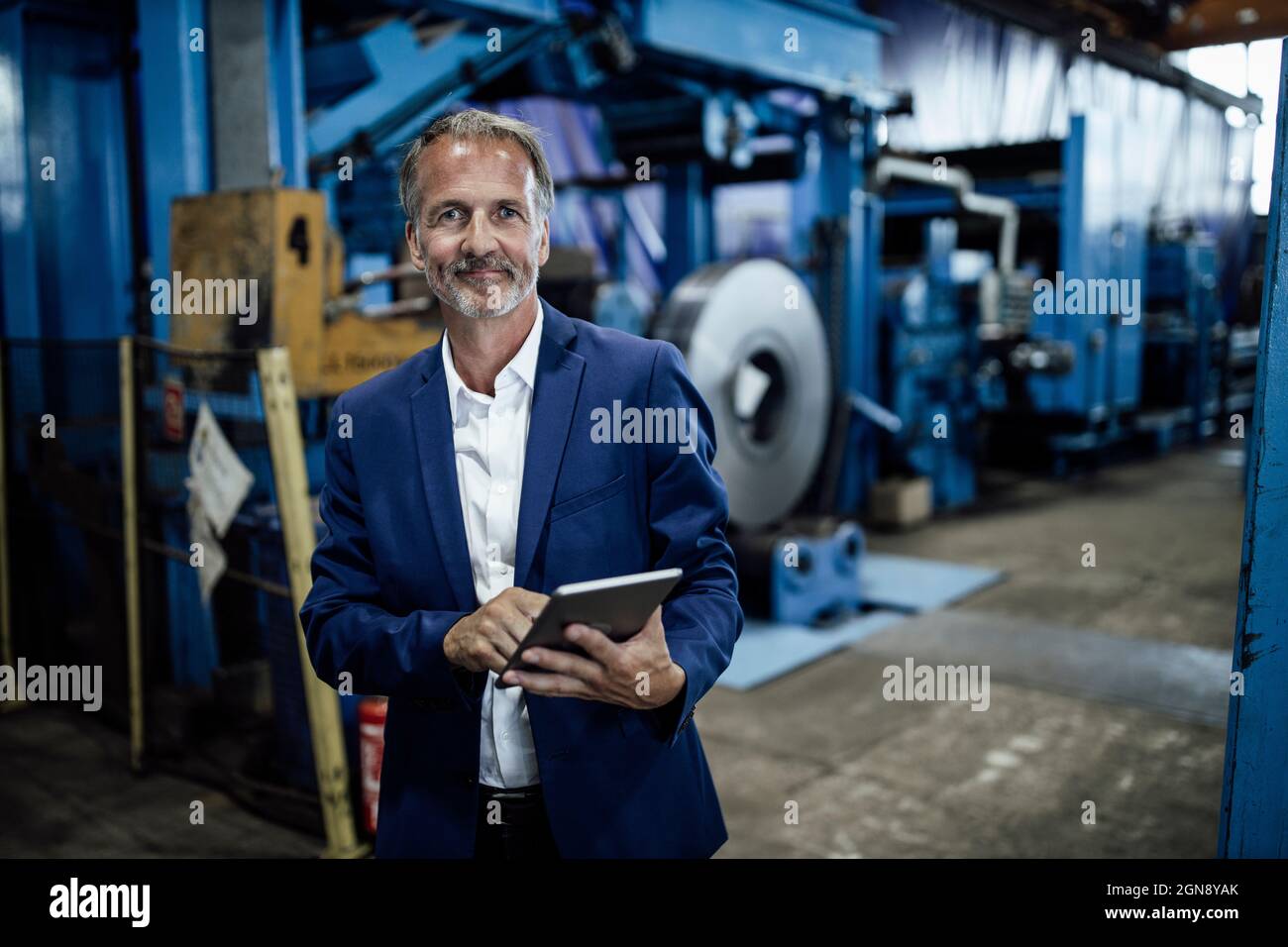 Leitender männlicher Inspektor mit digitalem Tablet im Stahlwerk Stockfoto