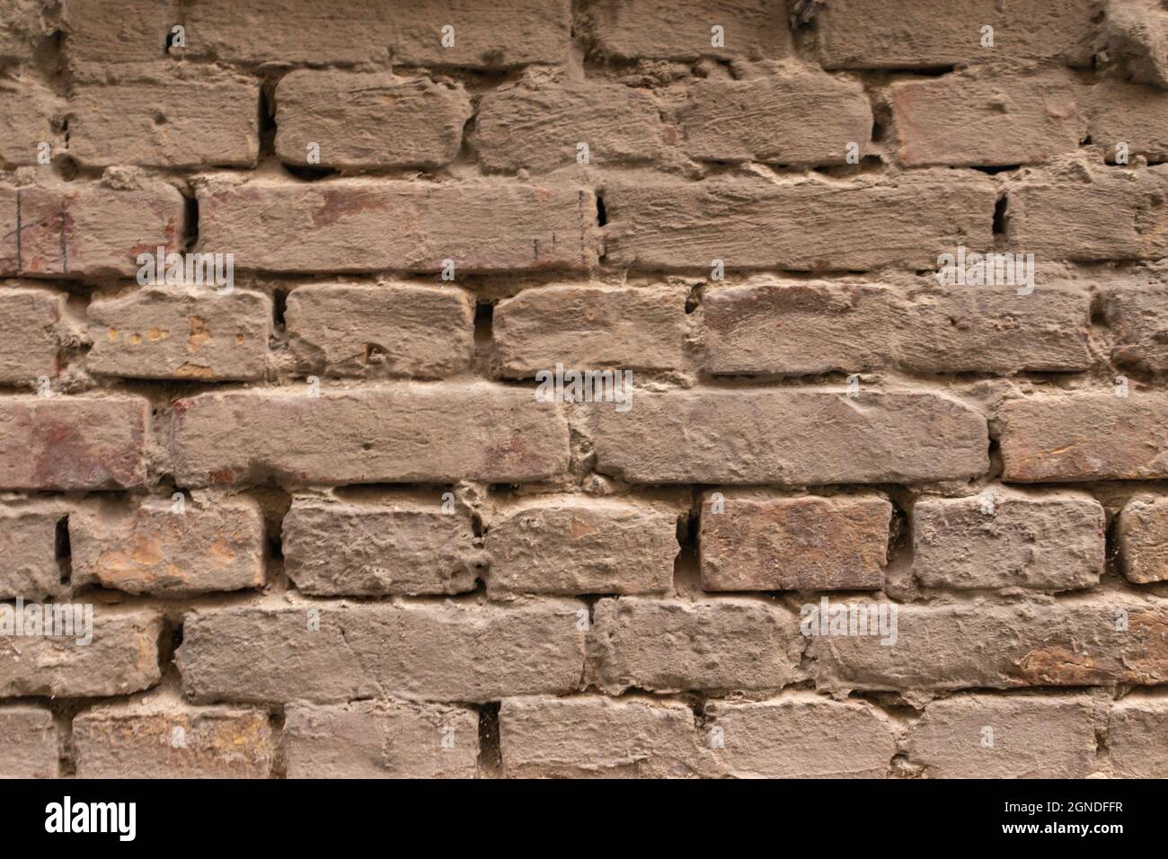 Grau Gunge Backstein Wand Hintergrund Stockfoto