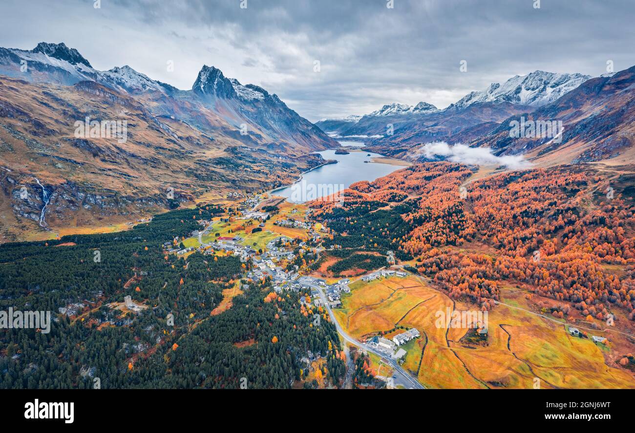 Blick von der fliegenden Drohne. Düsterer Herbstblick auf den Sils See. Dramatische Morgenszene der Schweizer Alpen. Luftaufnahme im Freien des Dorfes Maloya, Schweiz, EU Stockfoto
