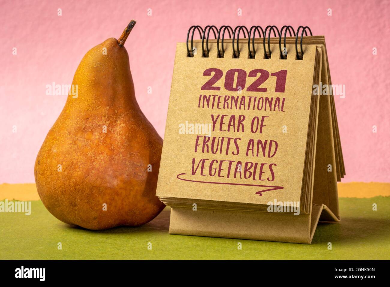 2021 Internationales Jahr der Früchte und Gemüse - Handschrift in einem spiralförmigen Desktop-Kalender mit einer Birne, die das Bewusstsein für die wichtige Rolle der f Stockfoto