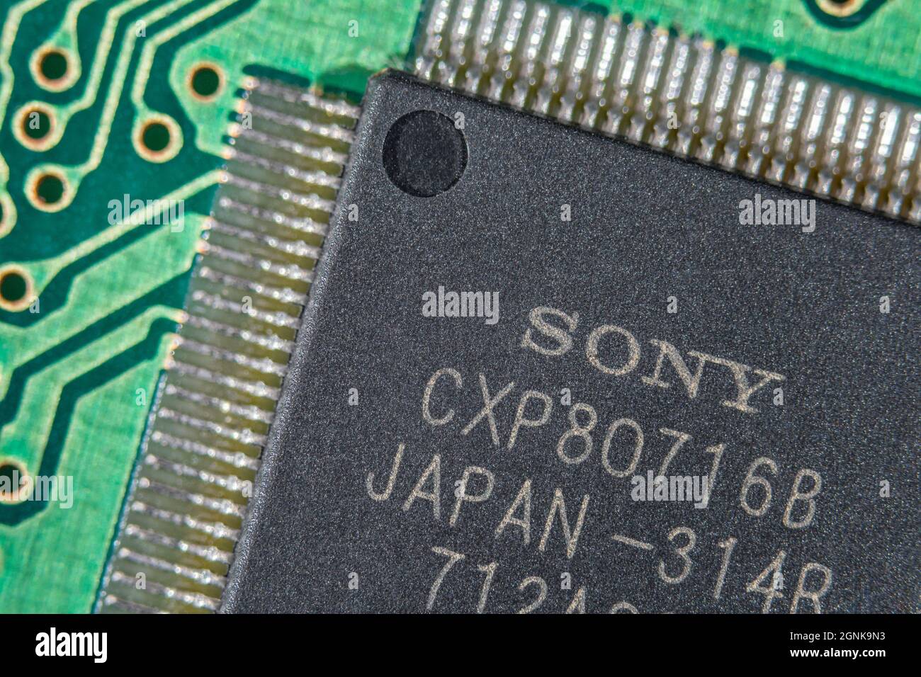 Flügelbeine oder Pinouts eines integrierten Halbleiters von Sony auf einer grünen leiterplatte. Für die Elektronik-Technologie, weltweite Chipknappheit Stockfoto