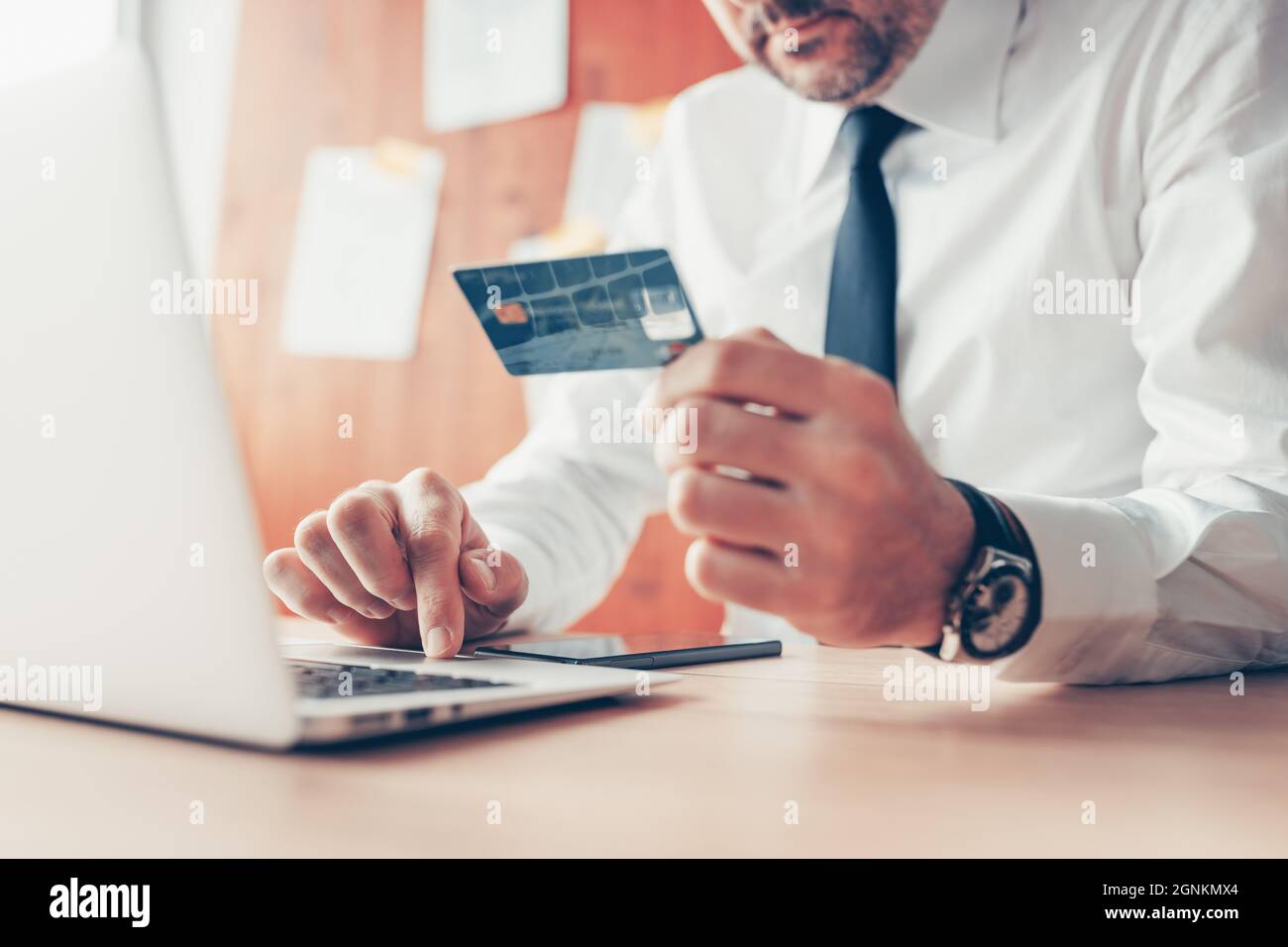E-Business, Geschäftsmann, der Kreditkarten- und Laptop-Computer für Online-Finanztransaktionen verwendet, Nahaufnahme mit selektivem Fokus Stockfoto