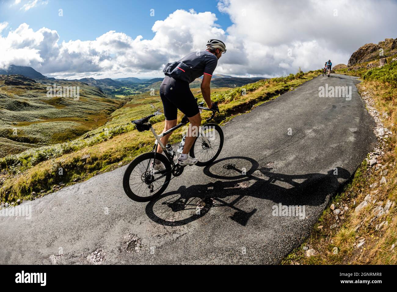 Rennradfahrer klettern 33% Steigung in der Fred Whitton Challenge, Hardknott Pass, Cumbria. Stockfoto