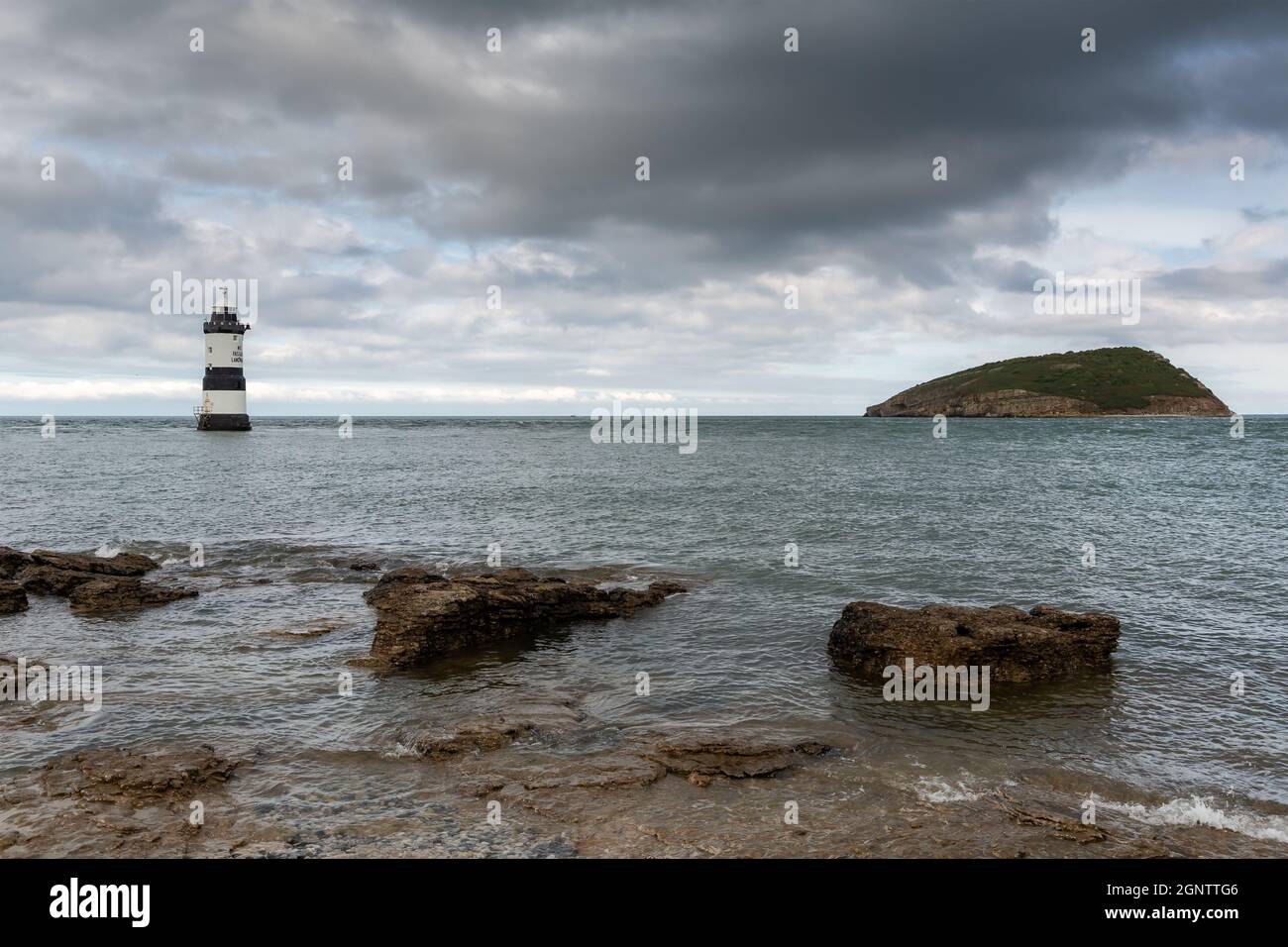 Penmon Point, Wales: Leuchtturm Trwyn Du und Puffin Island vor der Anglesey-Küste, mit Blick auf das irische Meer und den Eingang zur Menai-Meerenge. Stockfoto