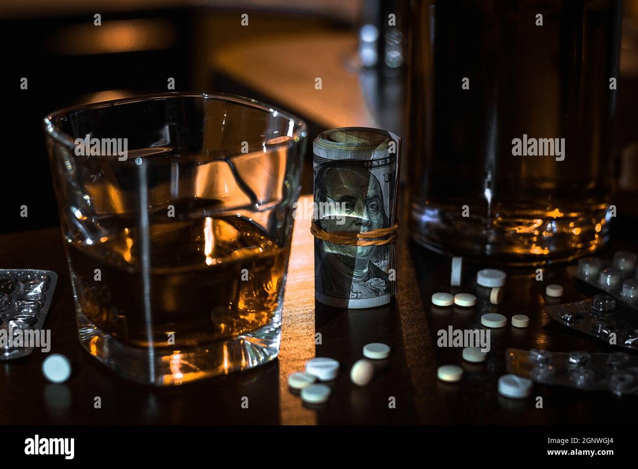 Geld, Pillen, Drogen und ein Glas Single Malt Whiskey Konzept schlechte Gewohnheiten, sucht Stockfoto