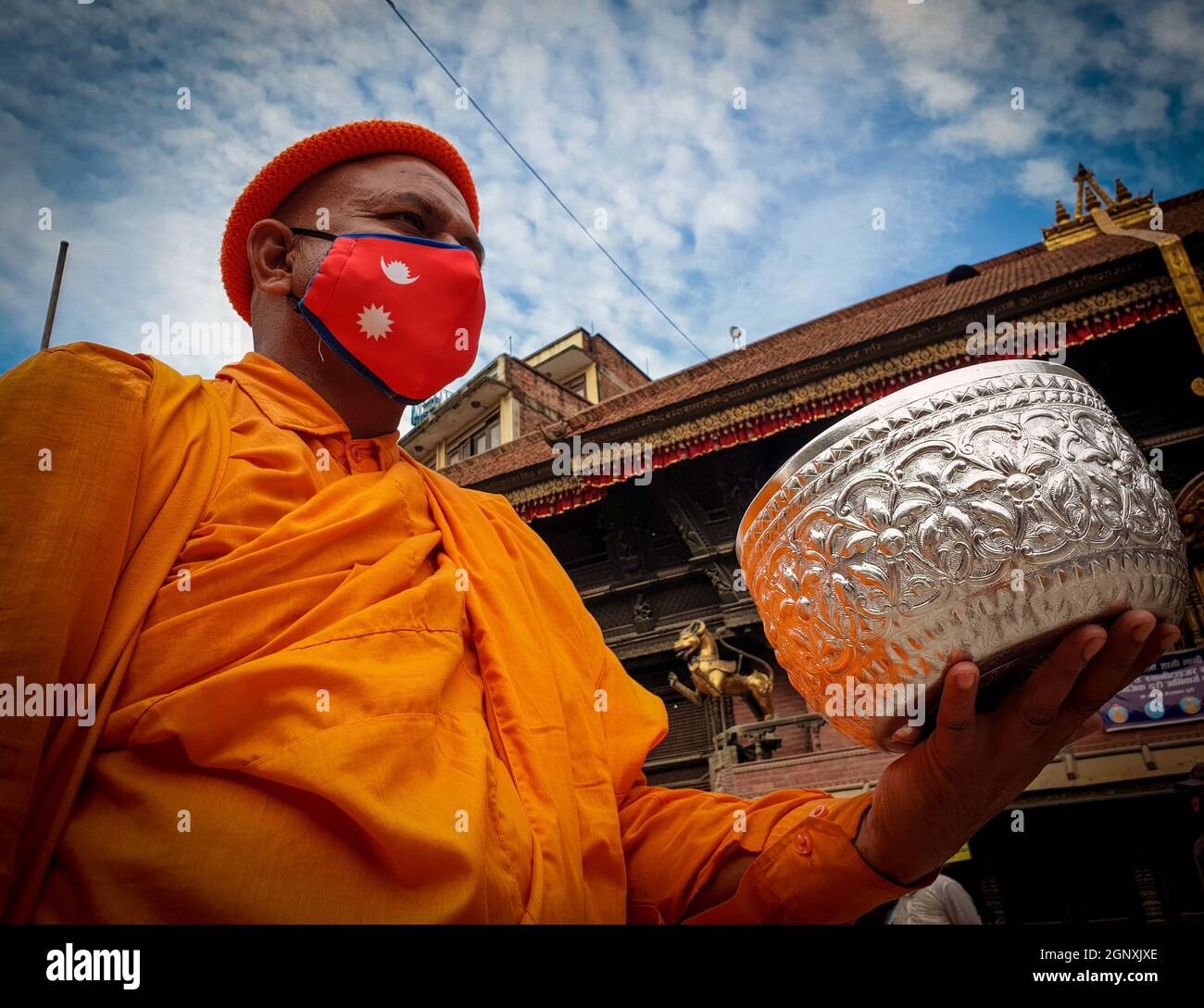 Kathmandu, Bagmati, Nepal. September 2021. Ein buddhistischer Mönch mit einer schützenden Gesichtsmaske wartet am 28. September 2021 vor einem Tempel in Kathmandu, der Hauptstadt Nepals, auf Almosen. (Bild: © Sunil Sharma/ZUMA Press Wire) Stockfoto