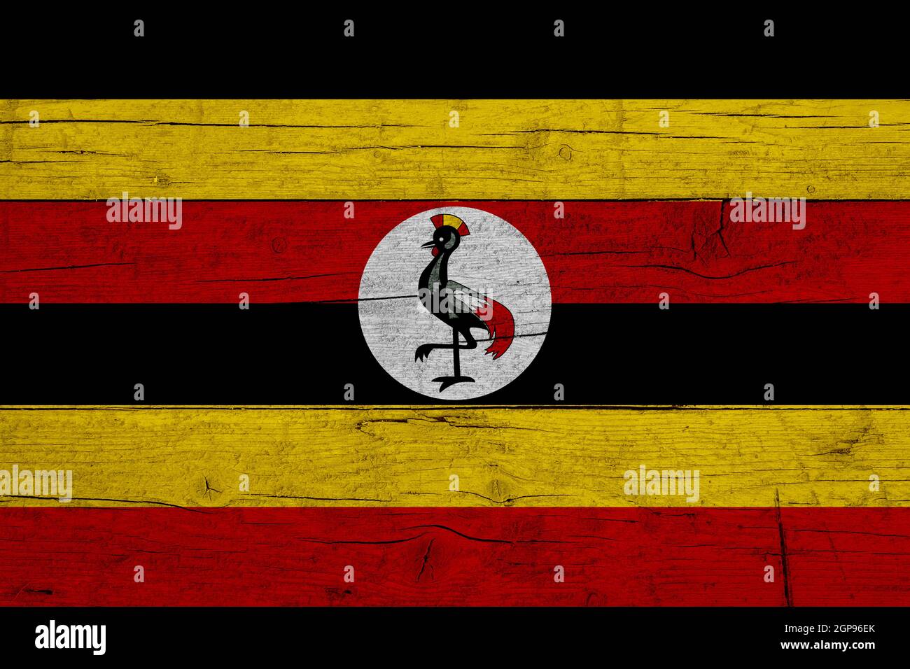 Flagge Ugandas. Holzstruktur der Flagge Ugandas. Stockfoto