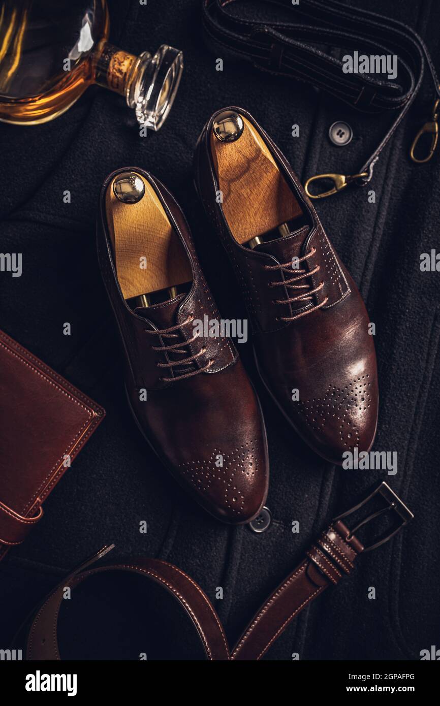 Herren Lederschuhe, Gürtel und Tagebuch auf dunklem Hintergrund, Draufsicht, flaches Lay Stockfoto