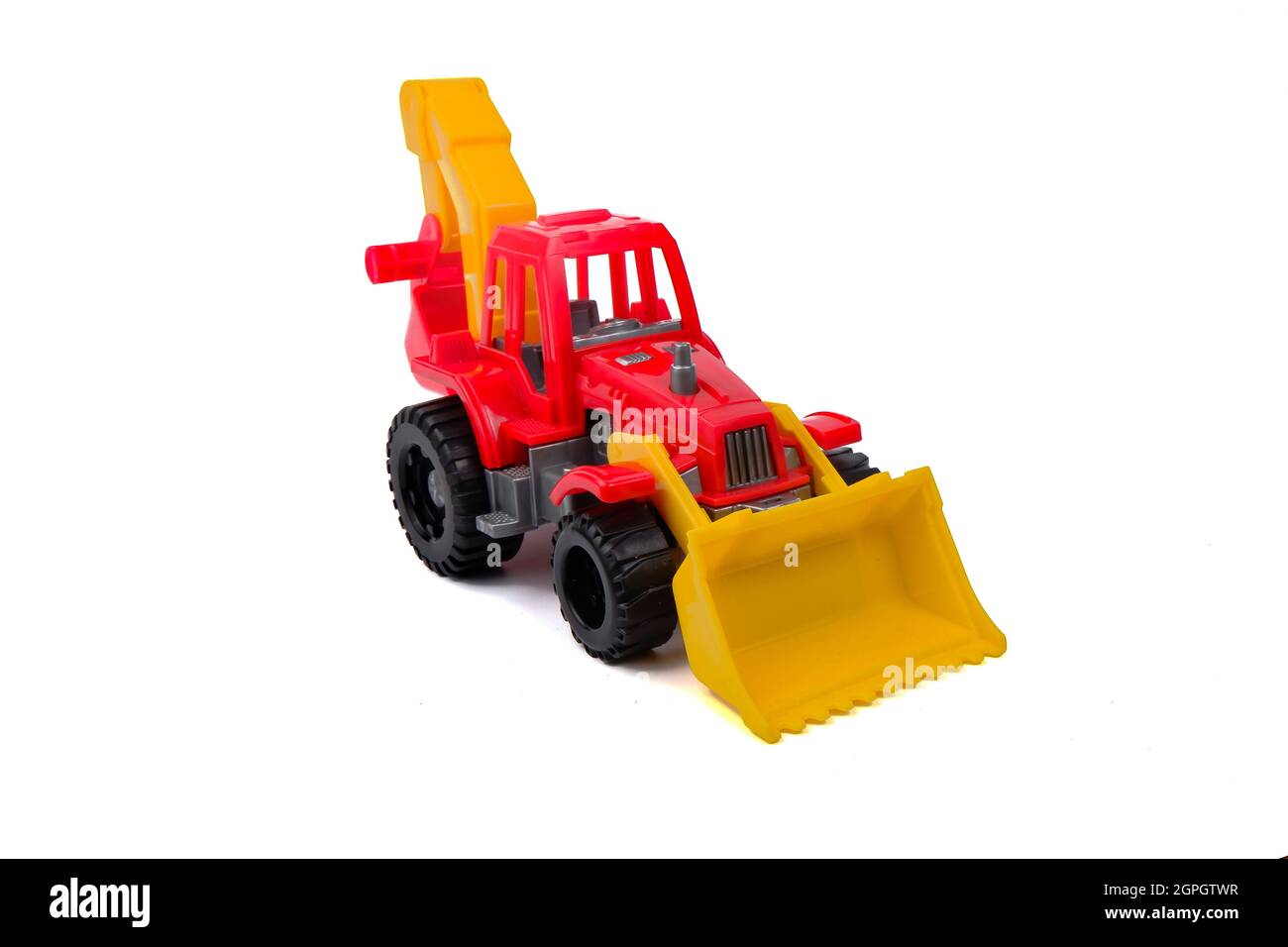 Kinderspielzeug aus rotem Kunststoff Traktor isoliert auf weißem Hintergrund Stockfoto