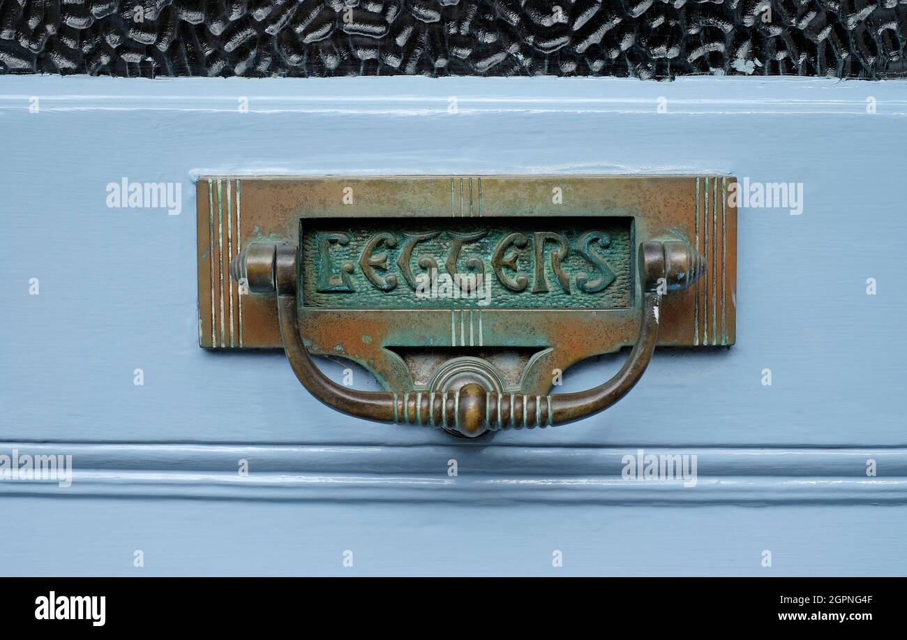 Verwitterter messingbriefkasten im viktorianischen Stil auf blau lackierter Haustür, yorkshire, england Stockfoto