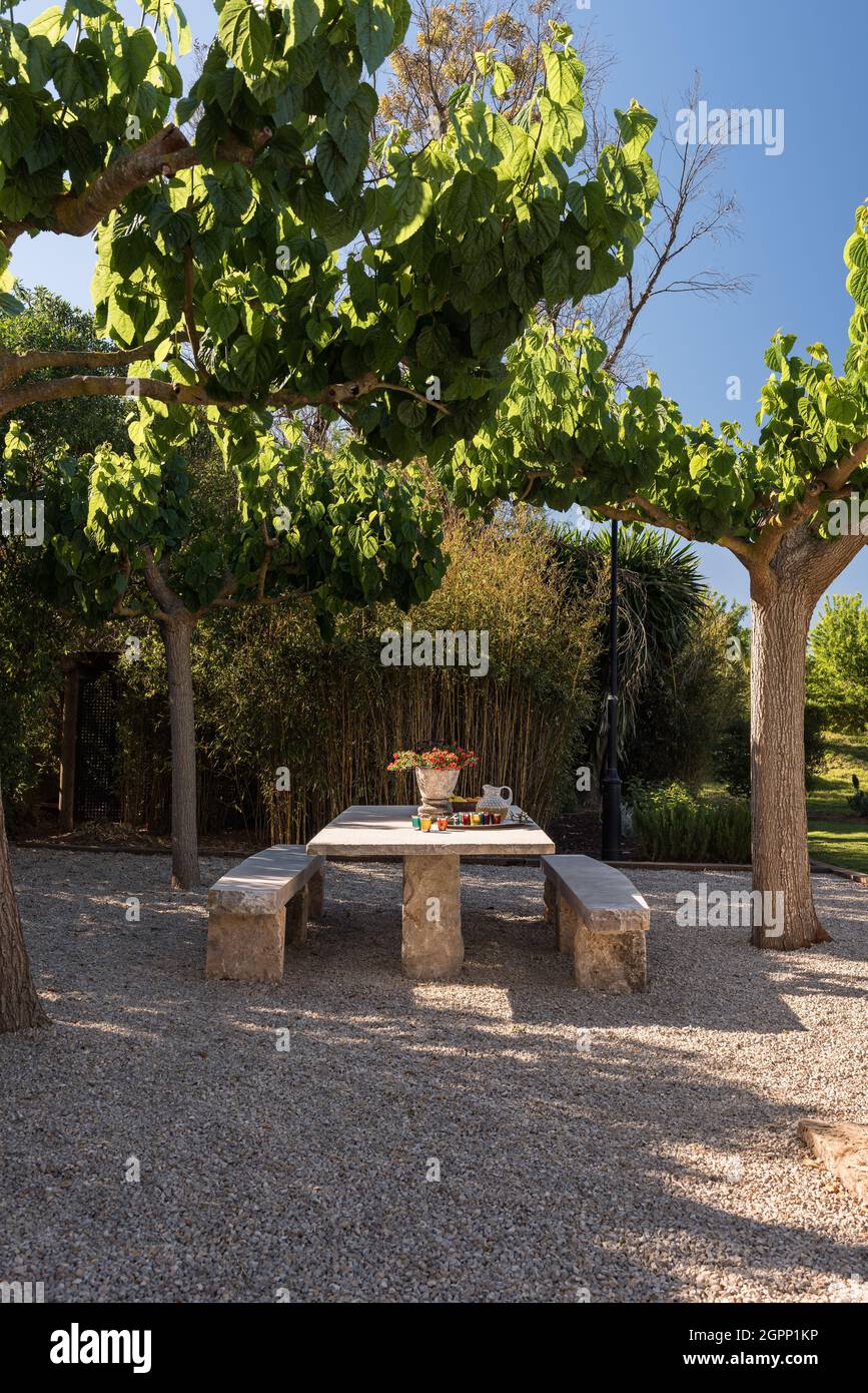 Sitzbank und Tisch auf der schattigen Terrasse der spanischen Villa, Mallorca Stockfoto