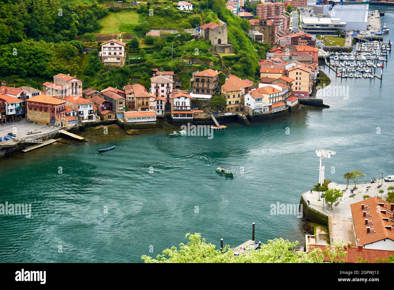 Blick auf das Fischerdorf mit seiner Uferpromenade und Booten in Pasai Donibane, Gipuzkoa, Baskenland, Spanien Stockfoto