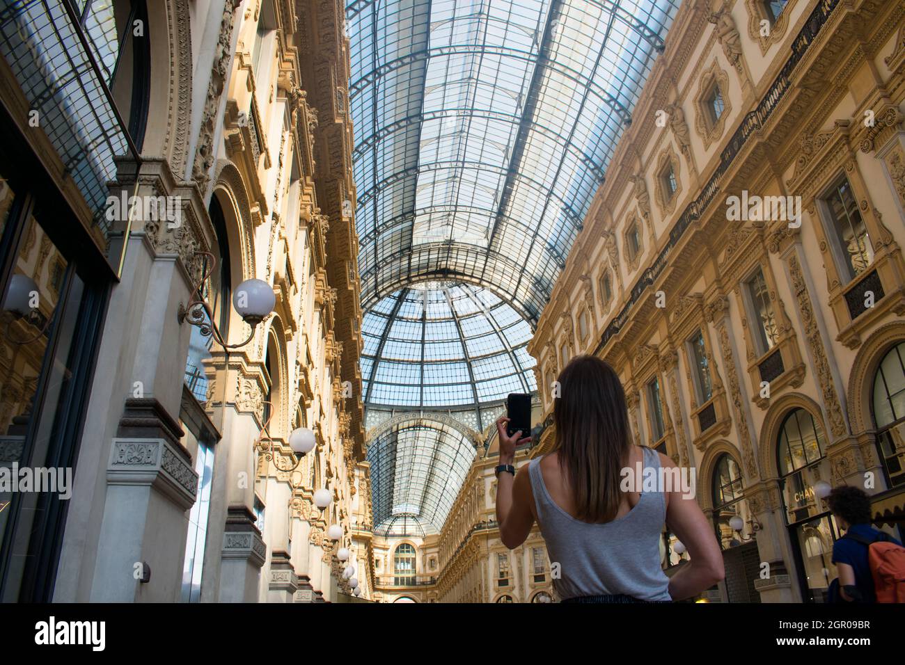 Weibliche Touristin, die mit dem Kameratelefon der Galleria Vittorio in Italien neben dem Duomo di Milano fotografiert Stockfoto