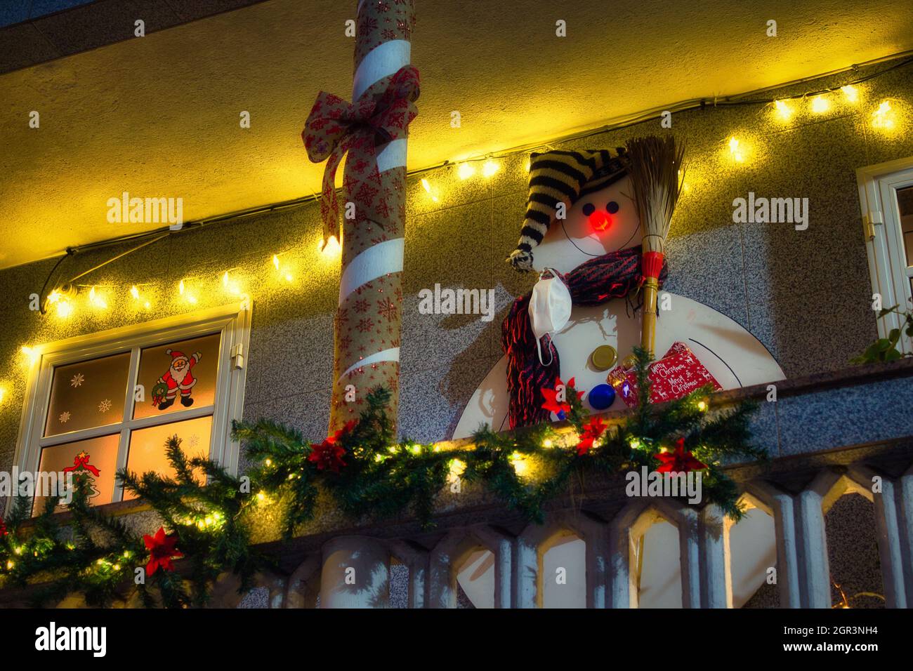 Weihnachtsschmuck auf einem Balkon, Schneemann, Band und Lichter Stockfoto