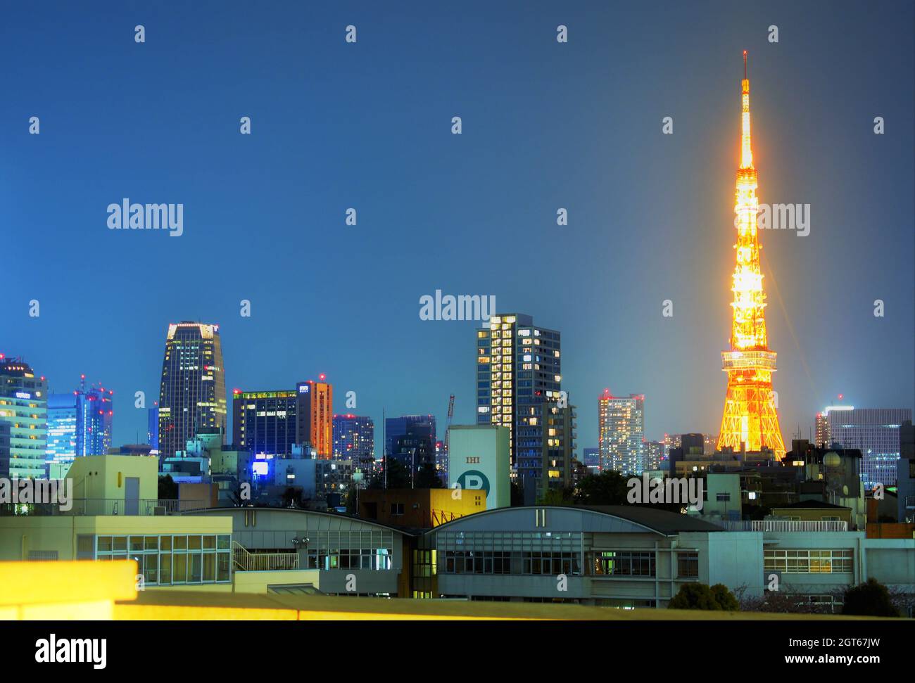Japans berühmter Tokyo Tower ist herrlich beleuchtet, während er über der Minato Night Skyline schwebt Stockfoto