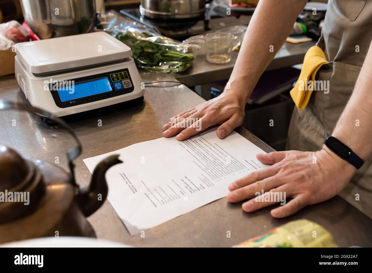 Der Bäcker schaut sich das Rezept an Stockfoto