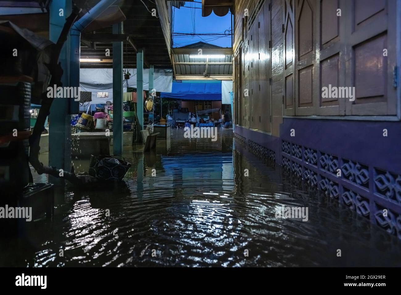 Nonthaburi, Thailand. Oktober 2021. Häuser werden nach einem starken Sturm überflutet dargestellt. Thailand ist aufgrund der starken Regenfälle, der Gezeitenwelle und der Wasserabflüsse vom Chao Phraya-Staudamm nach dem Sturm von Dianmu im Land mit einer Sturmflut konfrontiert. Viele Bewohner sind jedes Jahr mit Überschwemmungen konfrontiert, aber in diesem Jahr stieg der Wasserstand sofort an und verursachte mehr Schäden als üblich. Kredit: SOPA Images Limited/Alamy Live Nachrichten Stockfoto