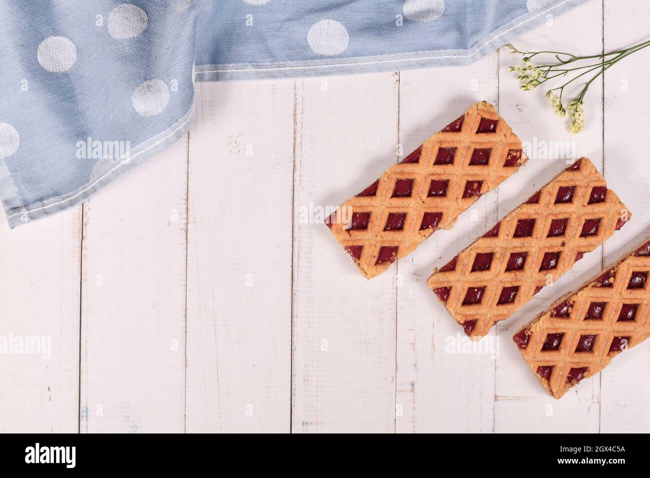Rechteckige Tortenscheiben namens „Linzer Torte“, ein traditionelles österreichisches Shortcake-Gebäck mit Fruchtkonserven und geschnittenen Nüssen mit Gittermuster auf s Stockfoto