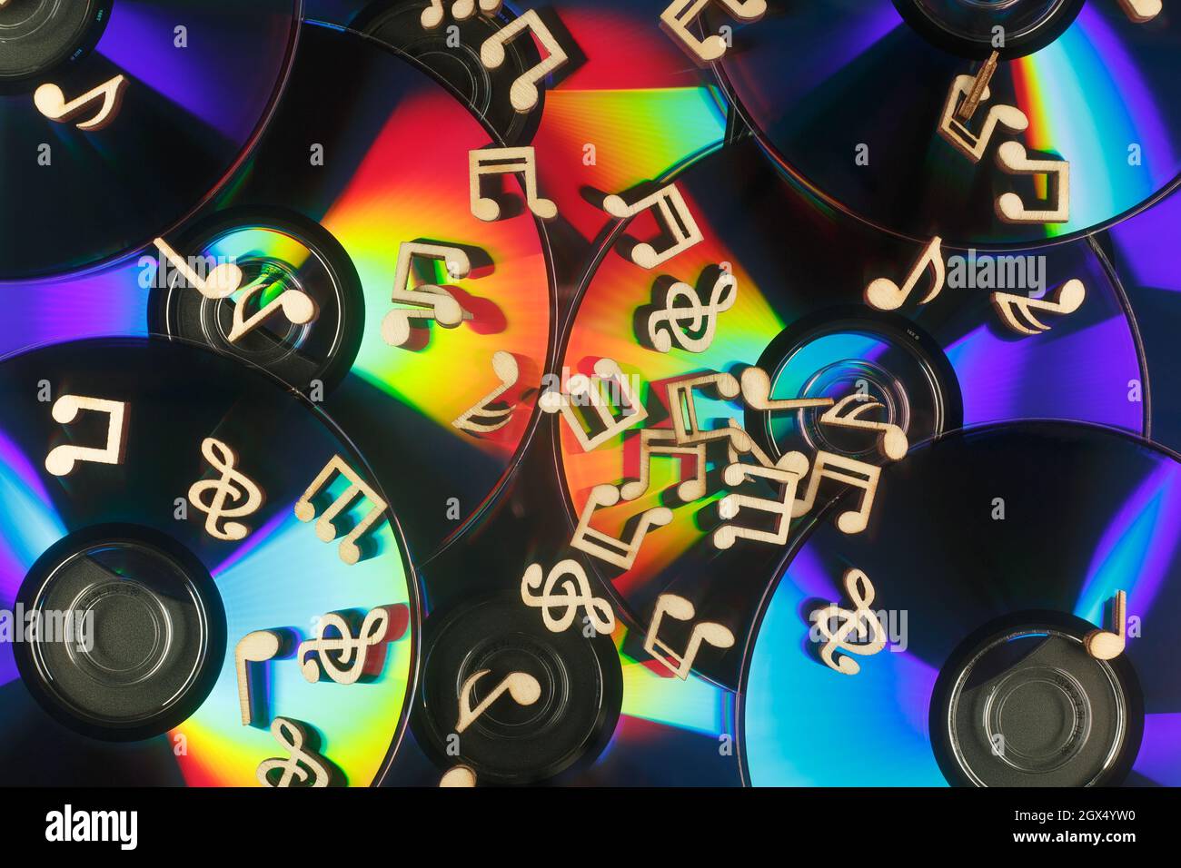 Musiknoten liegen auf der Oberfläche von CDs mit brechender Wirkung. Stockfoto