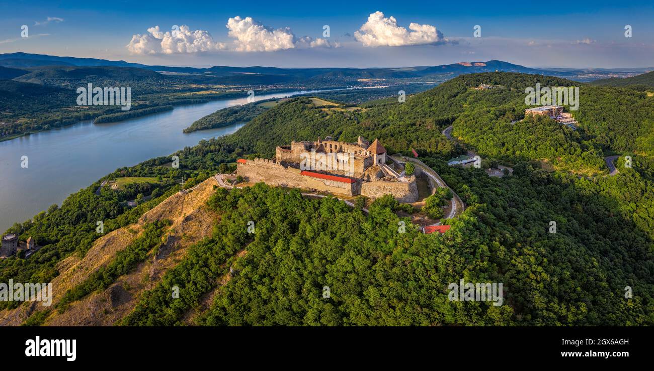 Visegrad, Ungarn - Luftpanoramic Drohne Blick auf die schöne hohe Burg von Visegrad mit Sommer Laub und Bäumen. Dunakanyar und blauer Himmel mit c Stockfoto