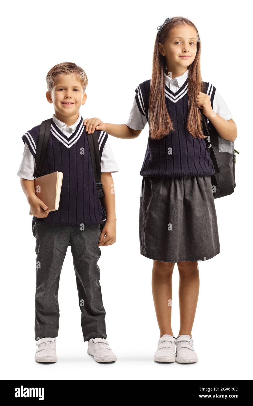 Bruder und ältere Schwester in Schuluniformen isoliert auf weißem Hintergrund Stockfoto