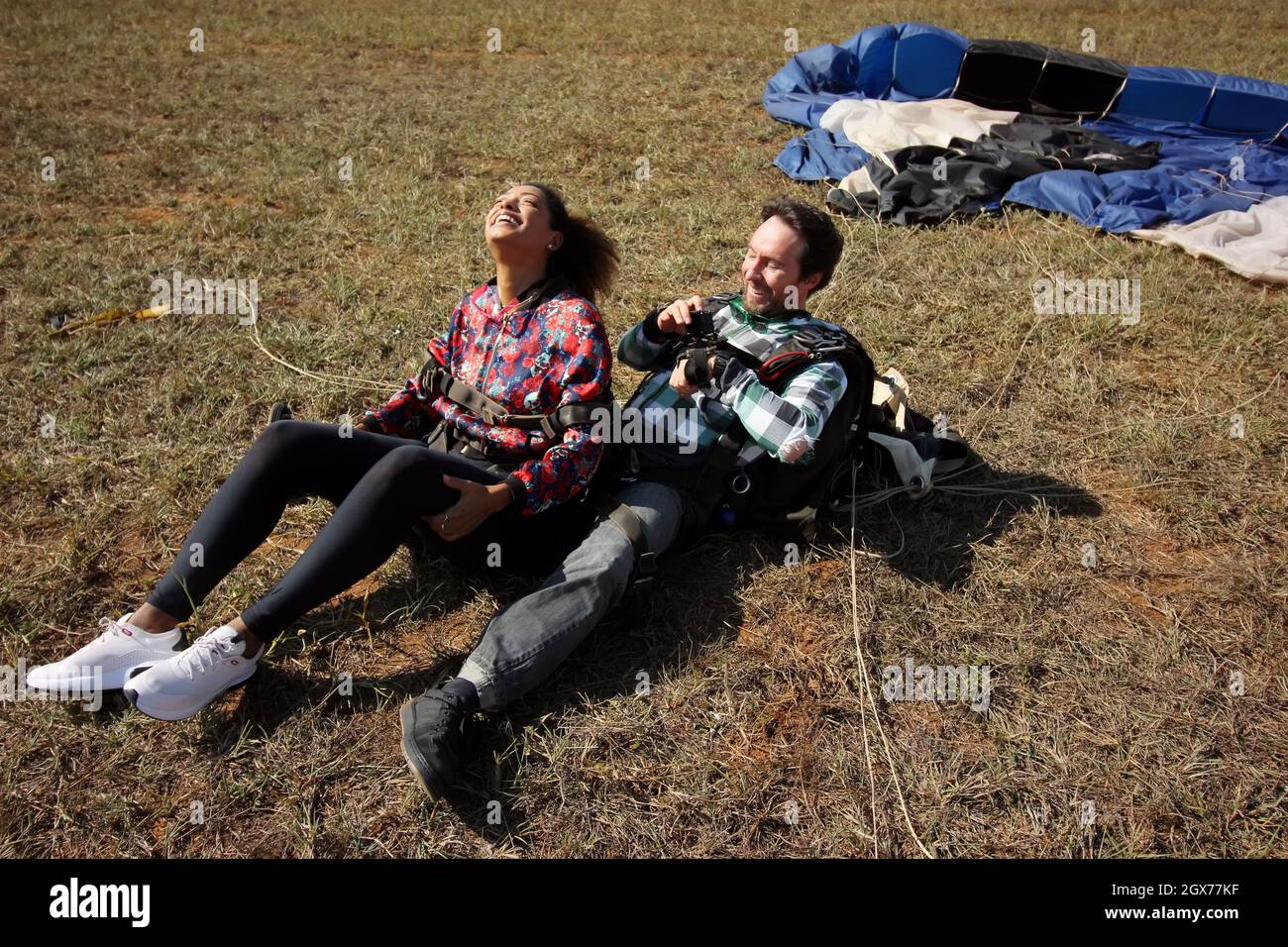 Tandemspringen mit Fallschirm. Schöne brasilianische Frau. Stockfoto