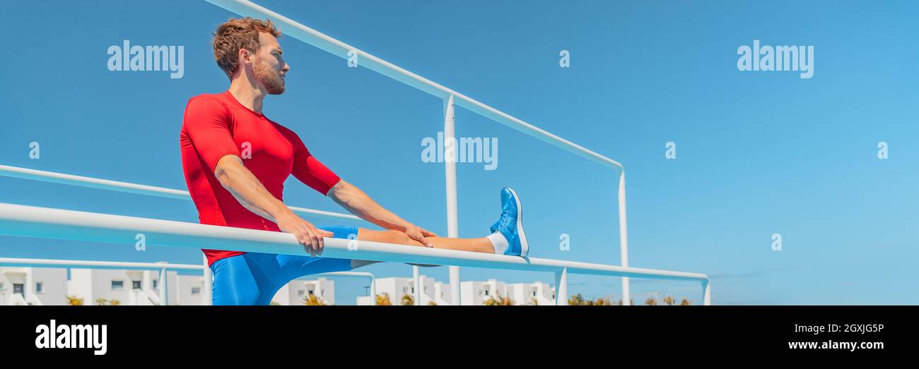 Stretch-Training fit Athlet Mann Stretching Beinmuskeln an athletischen Bars im Outdoor-Fitness-Studio. Aktive gesunde Lebensweise Person tun Beine warm up für Stockfoto