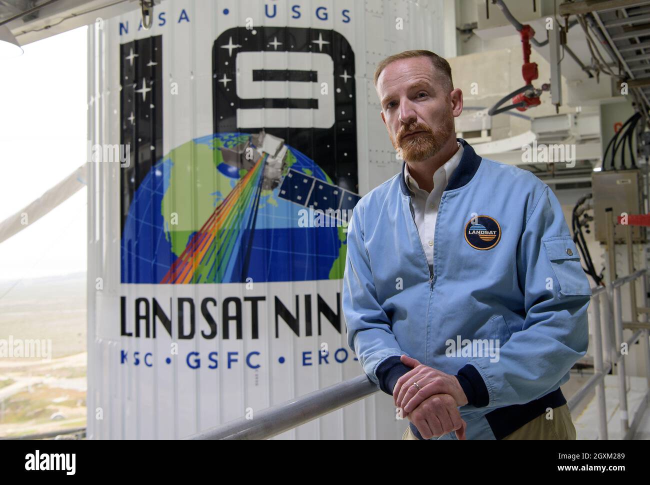 Schauspieler Marc Evan Jackson posiert mit der United Launch Alliance ATLAS V Rakete und der NASA Landsat 9 Raumsonde auf dem Space Launch Complex 3, Vandenberg Space Force Base 26. September 2021 in Lompoc, Kalifornien. Jackson spielte 2017 einen Landsat-Wissenschaftler in dem Film Kong Skull Island. Stockfoto